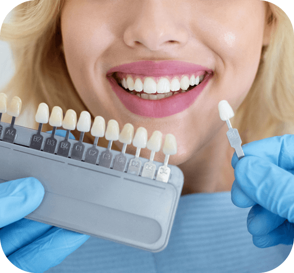 A cheerful woman holds a toothbrush, smiling as she promotes good oral health practices.